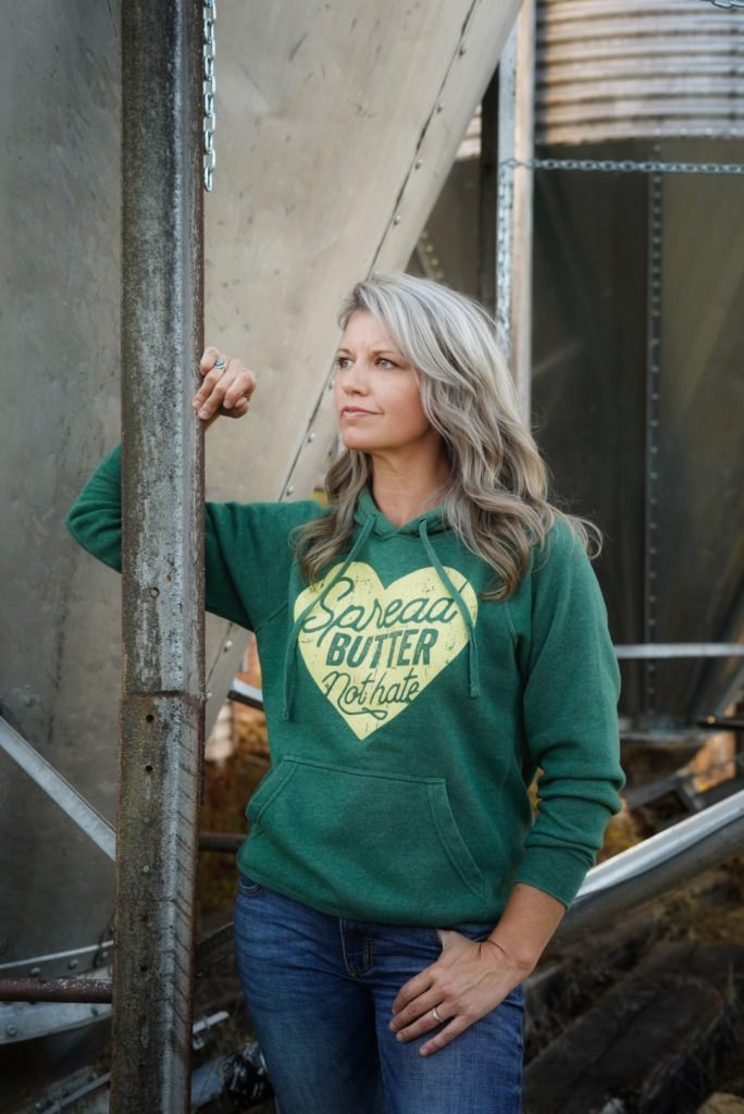 this farm wife leaning on grain bin