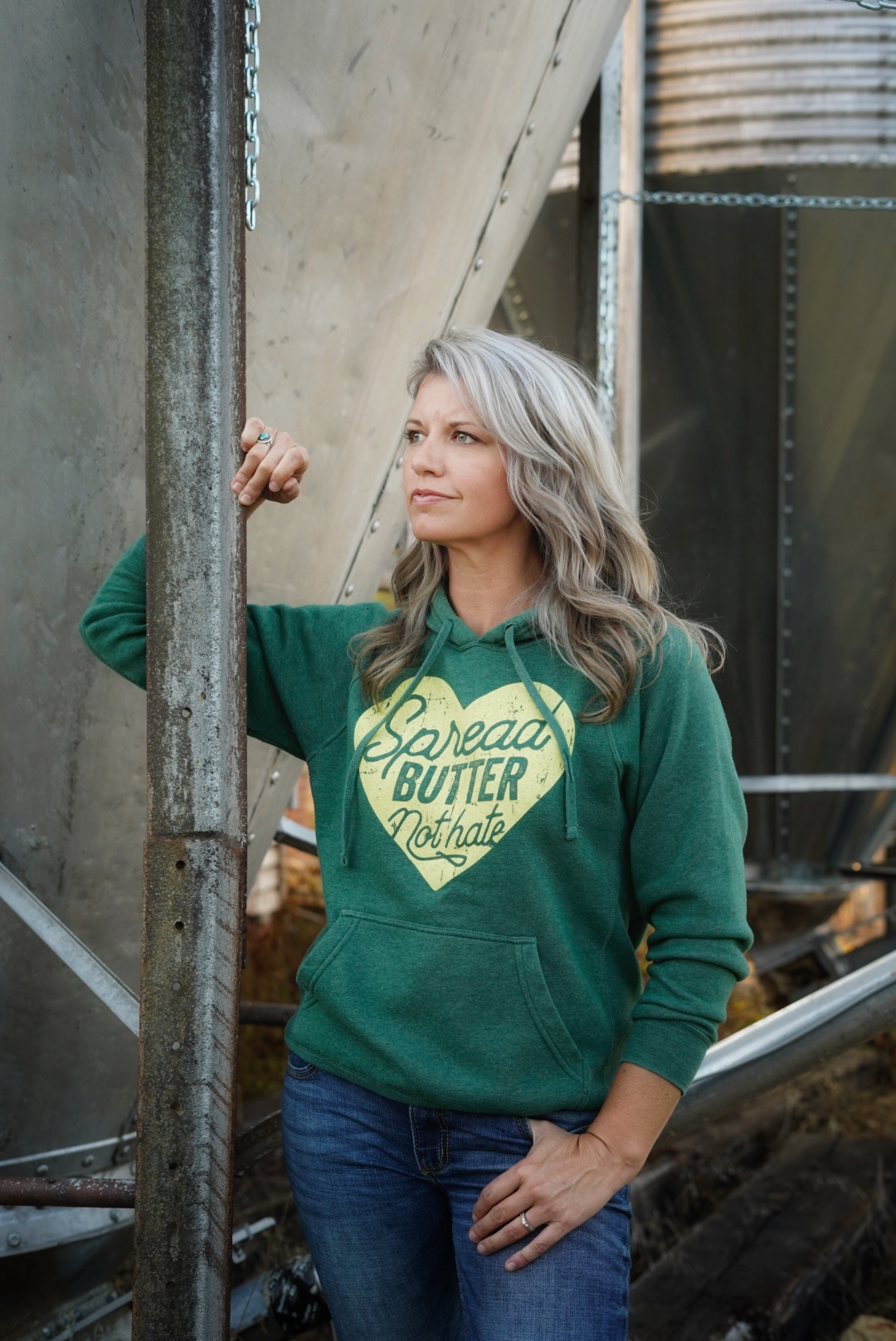 this farm wife leaning on grain bin